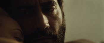Movie still from “Enemy” (2013), directed by Denis Villeneuve – A man's face with a beard; Extreme Close Up shot, Low angle