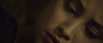 Movie still from “Enemy” (2013), directed by Denis Villeneuve – A woman's face in the dark; Extreme Close Up shot, Overhead angle