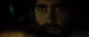 Movie still from “Enemy” (2013), directed by Denis Villeneuve – A person's face with a beard; Close Up shot, Over the shoulder angle