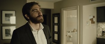 Movie still from “Enemy” (2013), directed by Denis Villeneuve – A man with a beard is standing in a bathroom; Close Up shot, Over the shoulder angle