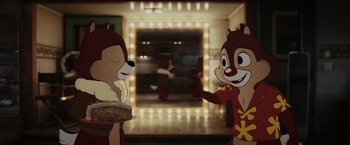 Movie still from “Chip 'n Dale: Rescue Rangers” (2022), directed by Akiva Schaffer – A couple of people that are holding some food; Medium shot, Over the shoulder angle