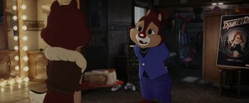 Movie still from “Chip 'n Dale: Rescue Rangers” (2022), directed by Akiva Schaffer – A cartoon of a chipmunk standing in front of a cake; Medium shot, Over the shoulder angle