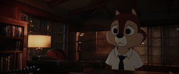 Movie still from “Chip 'n Dale: Rescue Rangers” (2022), directed by Akiva Schaffer – An animated character in a suit and tie looking sad; Medium shot, Over the shoulder angle