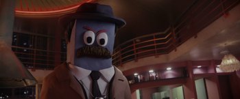 Movie still from “Chip 'n Dale: Rescue Rangers” (2022), directed by Akiva Schaffer – A man in a suit and a hat with a mustache; Close Up shot, Low angle