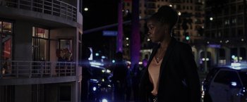 Movie still from “Chip 'n Dale: Rescue Rangers” (2022), directed by Akiva Schaffer – A woman standing in front of a window at night; Medium shot, Over the shoulder angle