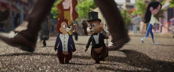 Movie still from “Chip 'n Dale: Rescue Rangers” (2022), directed by Akiva Schaffer – A couple of cardboard figures are standing on the ground; Wide shot, Over the shoulder angle