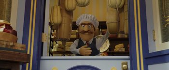 Movie still from “Chip 'n Dale: Rescue Rangers” (2022), directed by Akiva Schaffer – A man in a chef's hat and apron in front of a bakery; Medium shot, Low angle