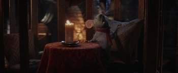 Movie still from “Chip 'n Dale: Rescue Rangers” (2022), directed by Akiva Schaffer – A mouse sitting on a table next to a candle; Medium shot, High angle
