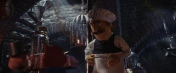 Movie still from “Chip 'n Dale: Rescue Rangers” (2022), directed by Akiva Schaffer – A puppet dressed as a chef; Medium shot, Over the shoulder angle