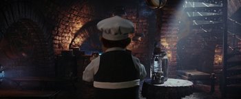 Movie still from “Chip 'n Dale: Rescue Rangers” (2022), directed by Akiva Schaffer – A child dressed as a chef in a kitchen; Medium shot, Over the shoulder angle