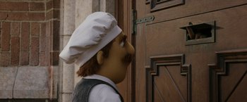 Movie still from “Chip 'n Dale: Rescue Rangers” (2022), directed by Akiva Schaffer – A person wearing a chef's hat standing in front of a door; Close Up shot, Low angle