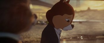 Movie still from “Chip 'n Dale: Rescue Rangers” (2022), directed by Akiva Schaffer – A cartoon of a bear wearing a suit and tie; Close Up shot, Over the shoulder angle