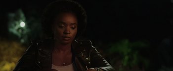 Movie still from “Chip 'n Dale: Rescue Rangers” (2022), directed by Akiva Schaffer – A woman wearing a leather jacket looking down; Close Up shot, Over the shoulder angle