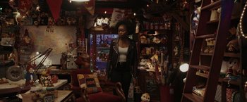 Movie still from “Chip 'n Dale: Rescue Rangers” (2022), directed by Akiva Schaffer – A woman standing in a room filled with lots of toys; Medium shot, Over the shoulder angle