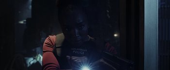 Movie still from “Chip 'n Dale: Rescue Rangers” (2022), directed by Akiva Schaffer – A woman looking at her cell phone in the dark; Close Up shot, Low angle