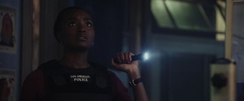 Movie still from “Chip 'n Dale: Rescue Rangers” (2022), directed by Akiva Schaffer – A police officer holding a flashlight up to her face; Close Up shot, Low angle