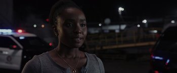 Movie still from “Chip 'n Dale: Rescue Rangers” (2022), directed by Akiva Schaffer – A young woman is standing in the dark; Close Up shot, Over the shoulder angle