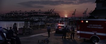 Movie still from “Chip 'n Dale: Rescue Rangers” (2022), directed by Akiva Schaffer – A group of people standing next to a police car at night; Extreme Wide shot, High angle