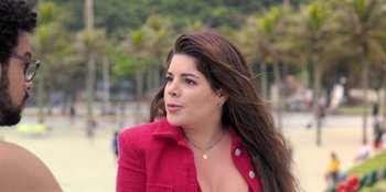 Movie still from “Christmas Full of Grace” (2022), directed by Pedro Antônio Paes – A woman in a pink jacket is looking to her left; Close Up shot, High angle