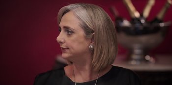 Movie still from “Christmas Full of Grace” (2022), directed by Pedro Antônio Paes – A person wearing a black shirt; Close Up shot, Low angle