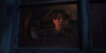 Movie still from “Chupa” (2023), directed by Jonás Cuarón – A young boy looking out of a car window at night; Close Up shot, Low angle