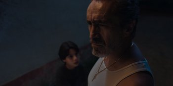 Movie still from “Chupa” (2023), directed by Jonás Cuarón – A man and a boy are looking at the camera; Close Up shot, Low angle
