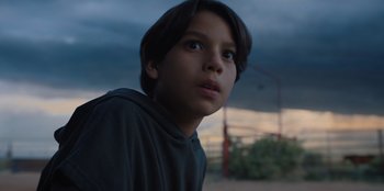 Movie still from “Chupa” (2023), directed by Jonás Cuarón – A young boy is looking into the distance; Close Up shot, Low angle