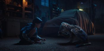 Movie still from “Chupa” (2023), directed by Jonás Cuarón – A girl sitting on the floor next to a cat; Wide shot, High angle
