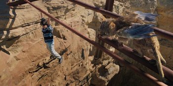Movie still from “Chupa” (2023), directed by Jonás Cuarón – A man is hanging from a metal bridge; Wide shot, High angle
