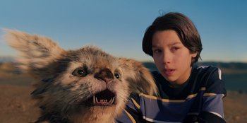 Movie still from “Chupa” (2023), directed by Jonás Cuarón – A girl and a stuffed animal dog are posing for a picture; Close Up shot, Low angle