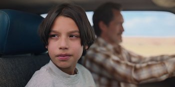 Movie still from “Chupa” (2023), directed by Jonás Cuarón – A young boy and an older man in a car; Close Up shot, Over the shoulder angle