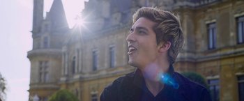 Movie still from “Cinderella” (2021), directed by Kay Cannon – A young man is looking up into the sky; Close Up shot, Low angle