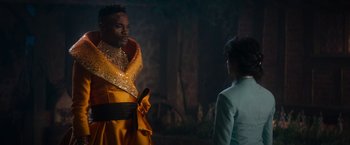 Movie still from “Cinderella” (2021), directed by Kay Cannon – A man and a woman are standing in front of each other; Medium shot, Over the shoulder angle