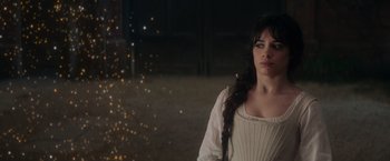 Movie still from “Cinderella” (2021), directed by Kay Cannon – A woman in a white dress standing in a room; Close Up shot, Over the shoulder angle