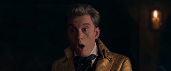 Movie still from “Cinderella” (2021), directed by Kay Cannon – A person wearing a suit and tie; Close Up shot, Low angle