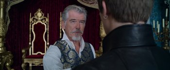 Movie still from “Cinderella” (2021), directed by Kay Cannon – A man in a vest looking into a mirror; Close Up shot, Over the shoulder angle