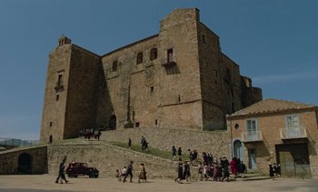Movie still from “Cinema Paradiso” (1988), directed by Giuseppe Tornatore – A group of people walking on a street next to a building; Extreme Wide shot, High angle