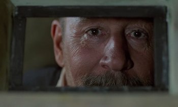 Movie still from “Cinema Paradiso” (1988), directed by Giuseppe Tornatore – A person with a beard; Extreme Close Up shot, Low angle