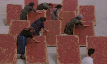 Movie still from “Cinema Paradiso” (1988), directed by Giuseppe Tornatore – A group of women working on a large piece of art; Wide shot, Overhead angle