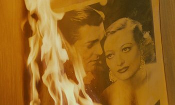 Movie still from “Cinema Paradiso” (1988), directed by Giuseppe Tornatore – An image of a man and a woman in front of a fire; Extreme Close Up shot, Overhead angle