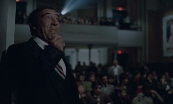 Movie still from “Cinema Paradiso” (1988), directed by Giuseppe Tornatore – A man standing in front of an audience in front of an audience; Medium shot, Low angle