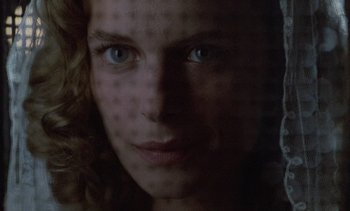 Movie still from “Cinema Paradiso” (1988), directed by Giuseppe Tornatore – A person's face in a dark room; Extreme Close Up shot, Low angle