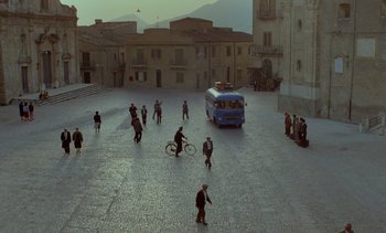 Movie still from “Cinema Paradiso” (1988), directed by Giuseppe Tornatore – A group of people walking around a street; Extreme Wide shot, High angle