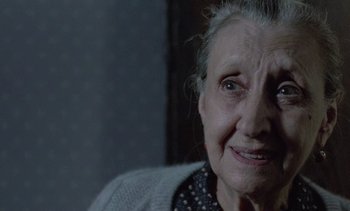 Movie still from “Cinema Paradiso” (1988), directed by Giuseppe Tornatore – An old woman with a very big smile on her face; Close Up shot, Over the shoulder angle