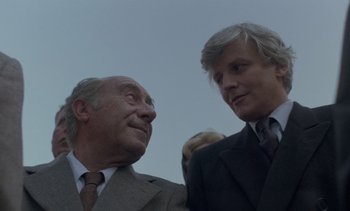 Movie still from “Cinema Paradiso” (1988), directed by Giuseppe Tornatore – Two men in suits talking to each other; Close Up shot, Low angle