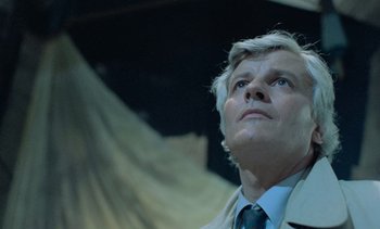 Movie still from “Cinema Paradiso” (1988), directed by Giuseppe Tornatore – A man in a suit and tie looking up; Close Up shot, Low angle