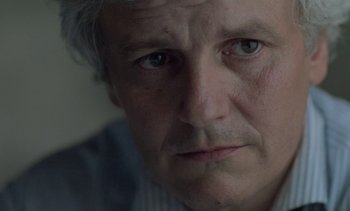 Movie still from “Cinema Paradiso” (1988), directed by Giuseppe Tornatore – An older man with a gray beard looking at the camera; Close Up shot, Low angle