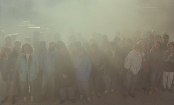 Movie still from “Cinema Paradiso” (1988), directed by Giuseppe Tornatore – A large group of people standing in the middle of the street; Wide shot, High angle