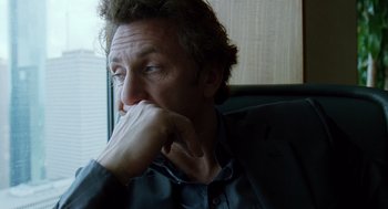 Movie still from “The Tree of Life” (2011), directed by Terrence Malick – A person sitting in a chair with his hand under his chin; Close Up shot, Over the shoulder angle