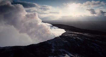 Movie still from “The Tree of Life” (2011), directed by Terrence Malick – A view of a mountain with clouds coming from it; Extreme Wide shot, High angle
